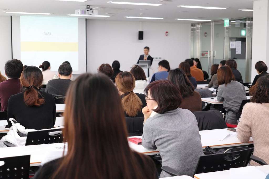 A presenter lectures a classroom
