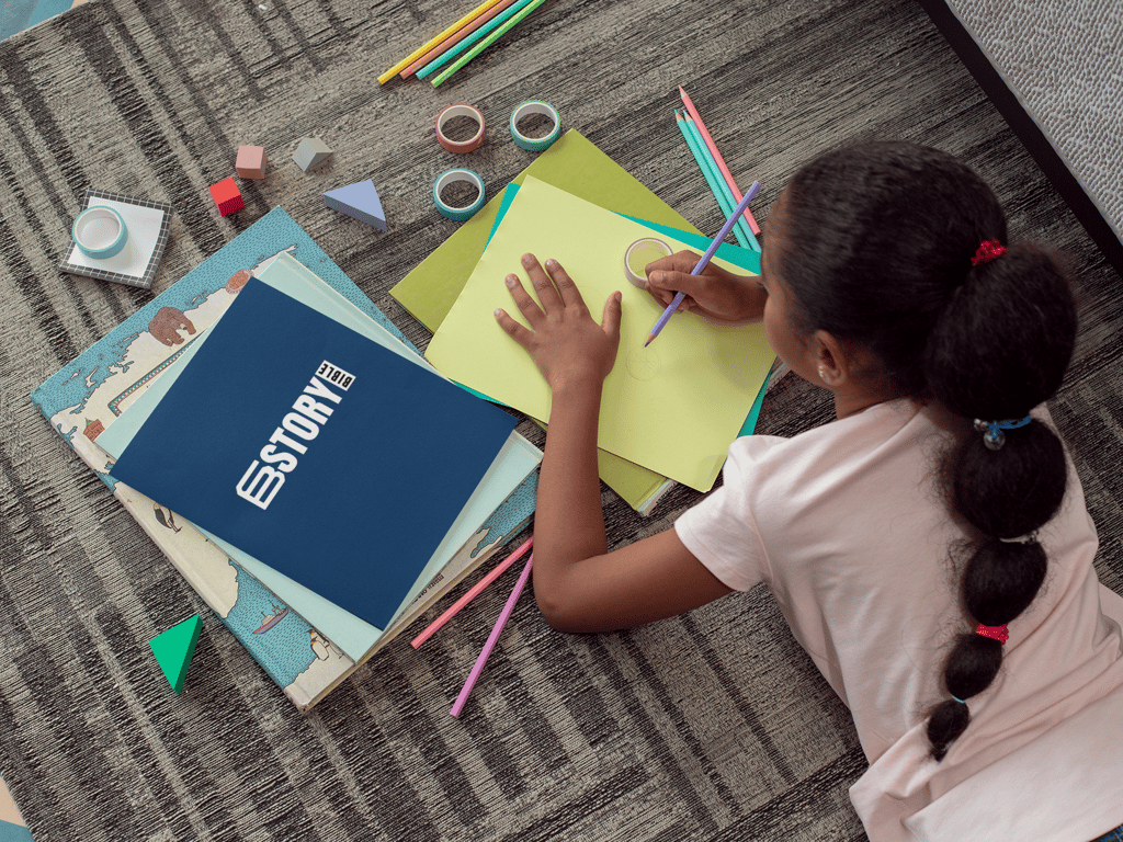 Girl with her printed copy of Story Bible