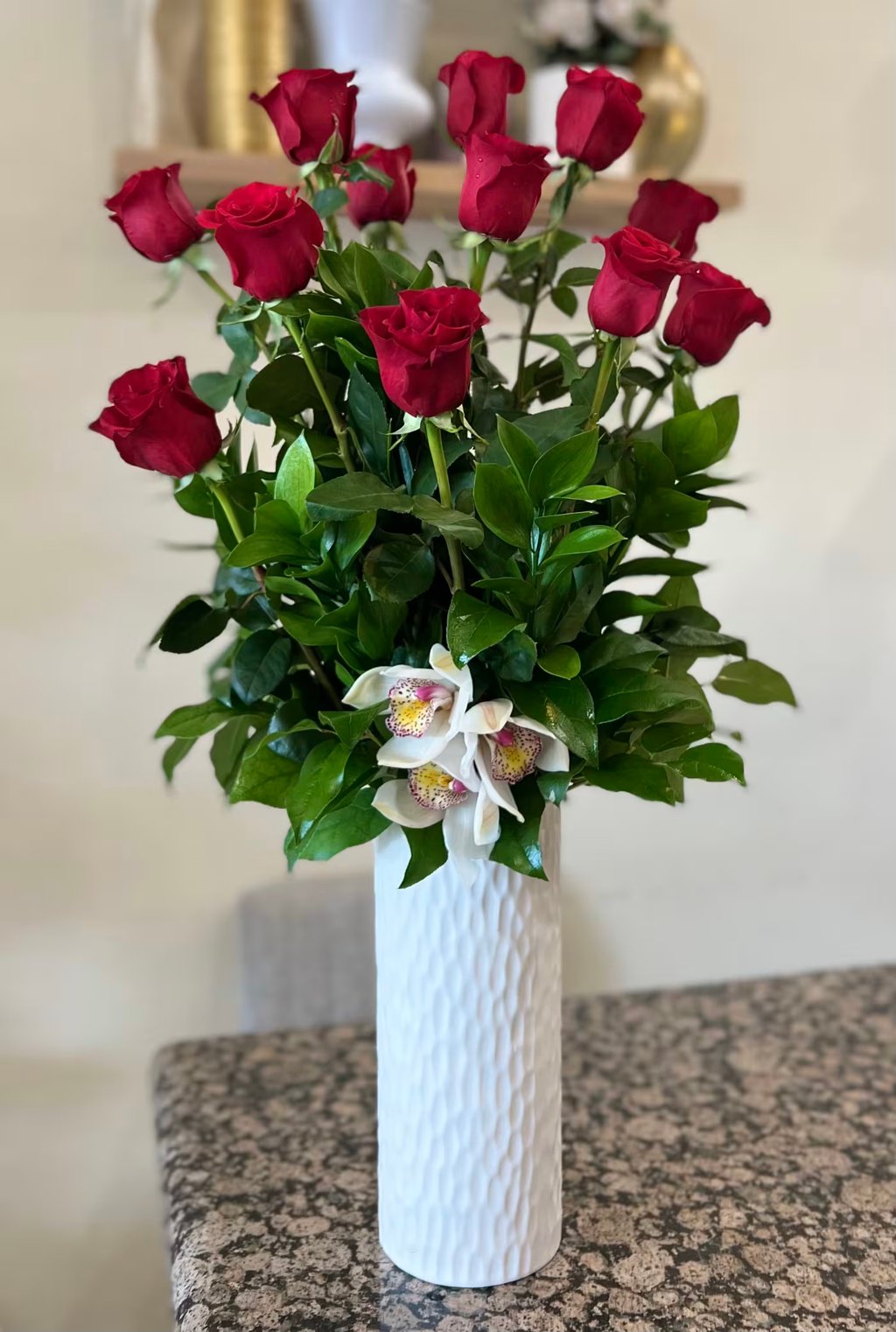 A Dozen Long Stemmed Red Roses in a Ceramic Vase