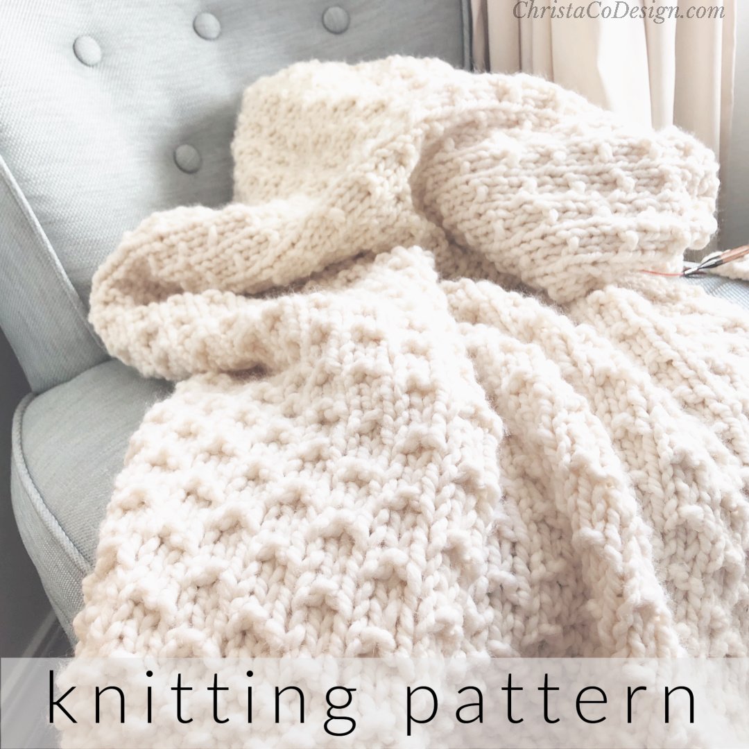 Cream white knit blanket on blue chair.
