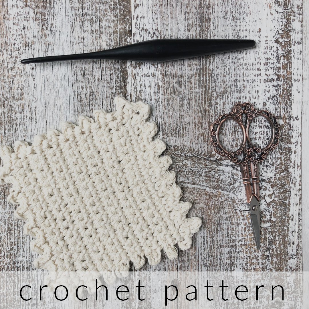 Cream crochet square coaster with hook and scissors.