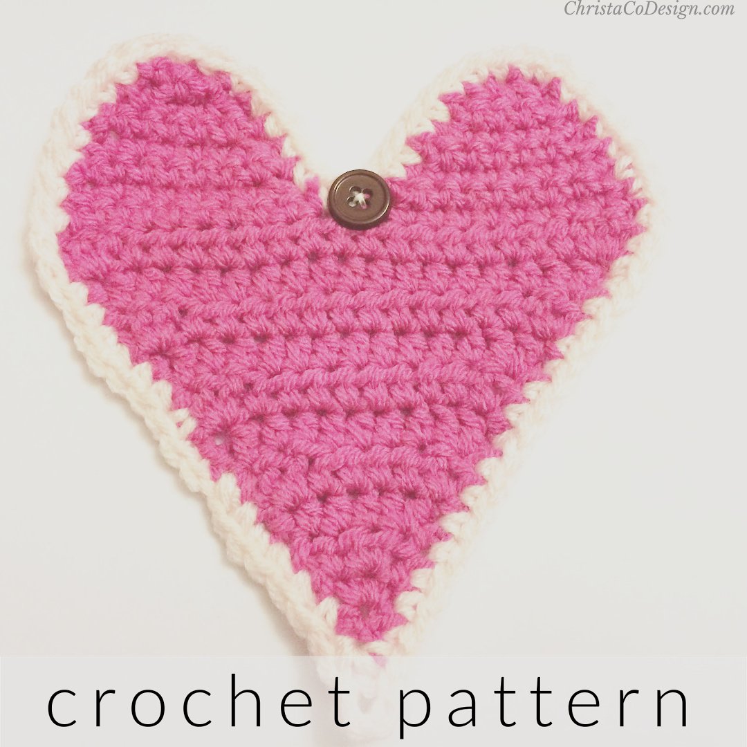 Pink crochet heart with button and loop to close around gift card.