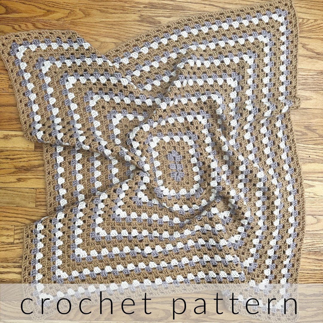 Rectangle granny blanket in purple brown and white on floor.