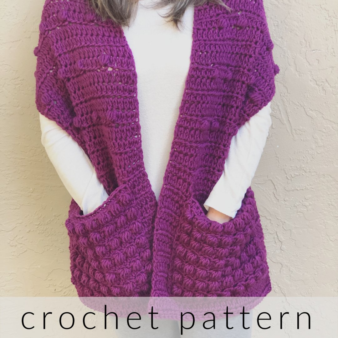 Crochet pattern text overlay on pocket shawl in purple.
