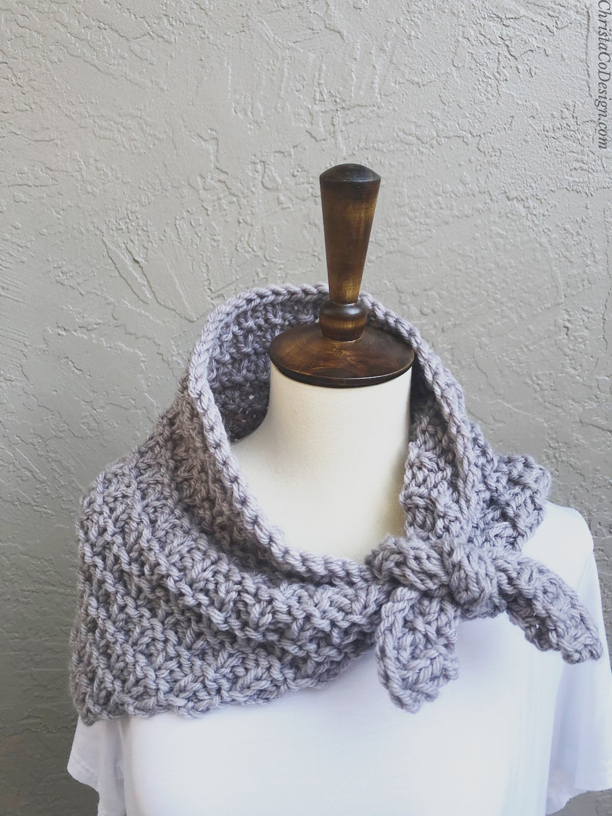 Purple knit neck warmer tied on mannequin.