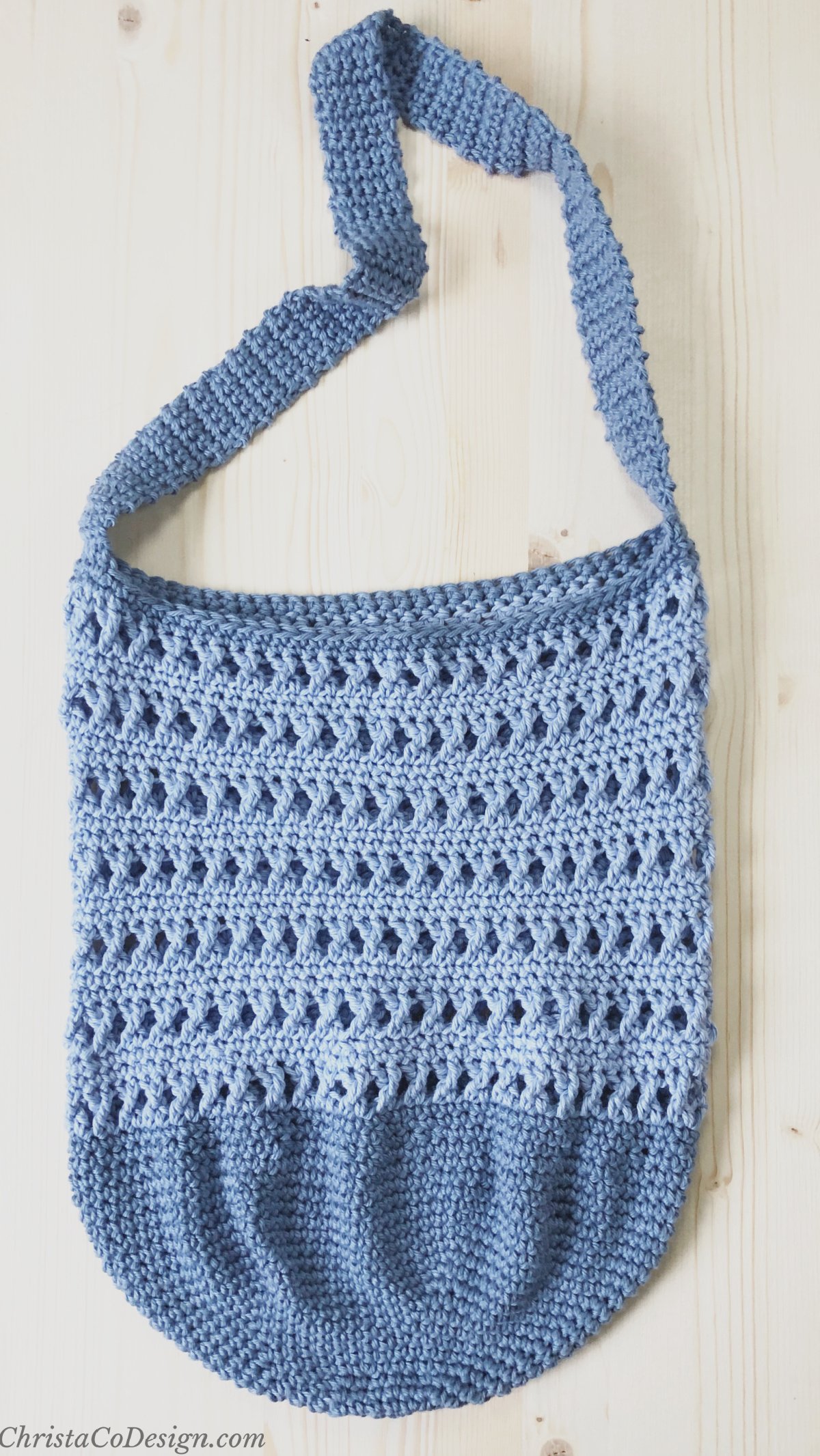 Top down view of flat crochet bag with treble stitches.