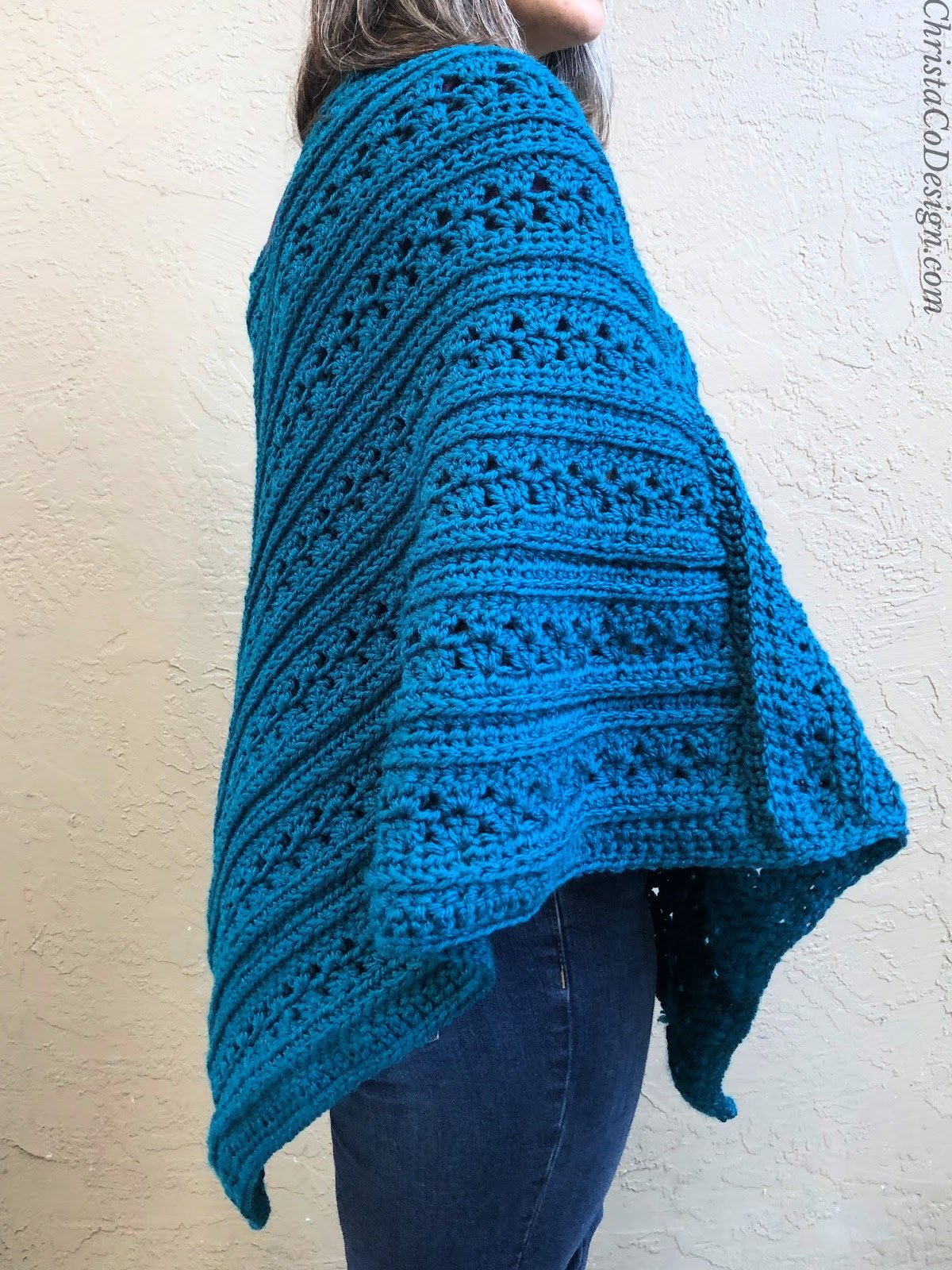 Side view of woman in crochet poncho.