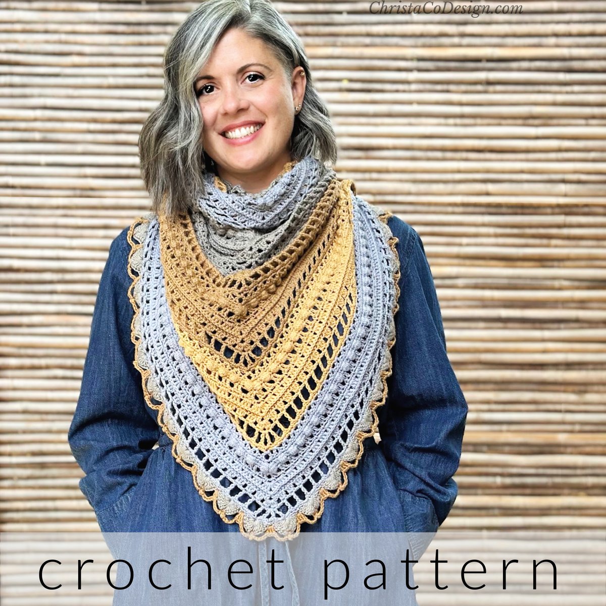 Woman smiling with hands in pocket with crochet shawl draped around neck as triangle scarf.
