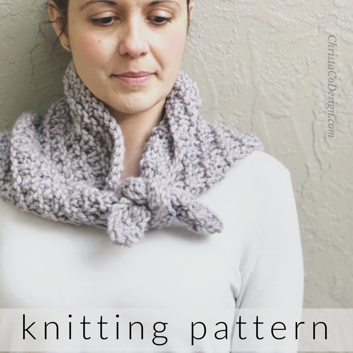 Woman with lavender knit neck warmer tied around neck. 