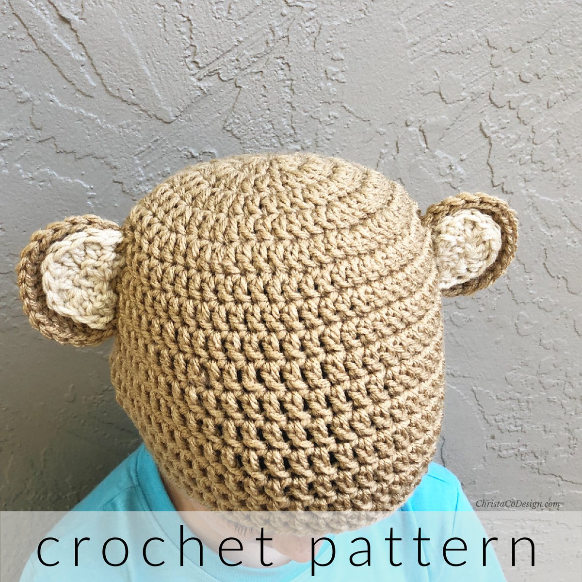 Boy wearing crochet bear hat.