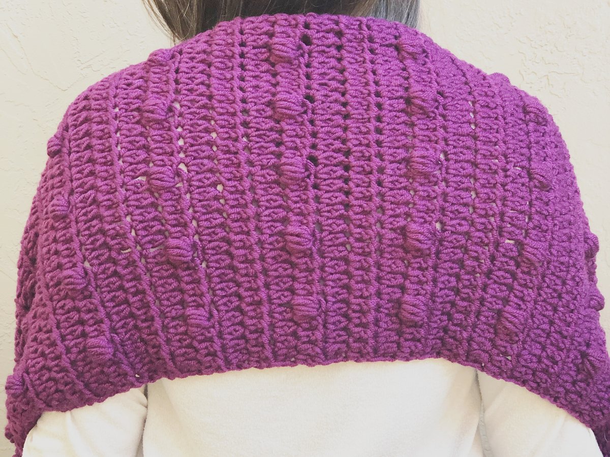 Back view of crochet pocket shawl with puff stitches.