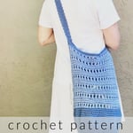 Woman with blue crochet bag over shoulder.
