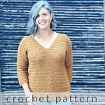 Woman smiling in crochet sweater with v-neck and 3/4 sleeves.