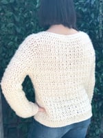 Back view of crochet sweater on woman.