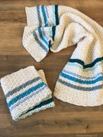 Striped towel and washcloth in creams and blues.