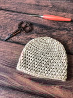Half double crochet beanie in cream with peach hook.