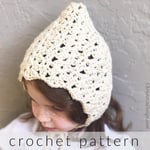  Girl with crochet bonnet on turned to side.