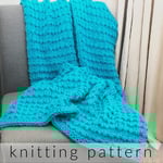 Bright blue textured knit blanket on grey chair.