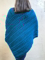Back of woman in blue crochet poncho.