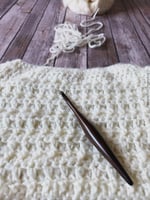 Work in progress of top down crochet sweater with wood hook.