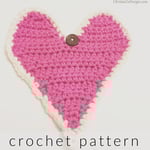 Pink crochet heart with button and loop to close around gift card.