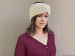 Woman looking down in chunky knit earwarmer.