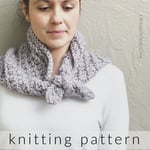 Woman with lavender knit neck warmer tied around neck. 