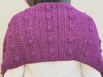 Back view of crochet pocket shawl with puff stitches.