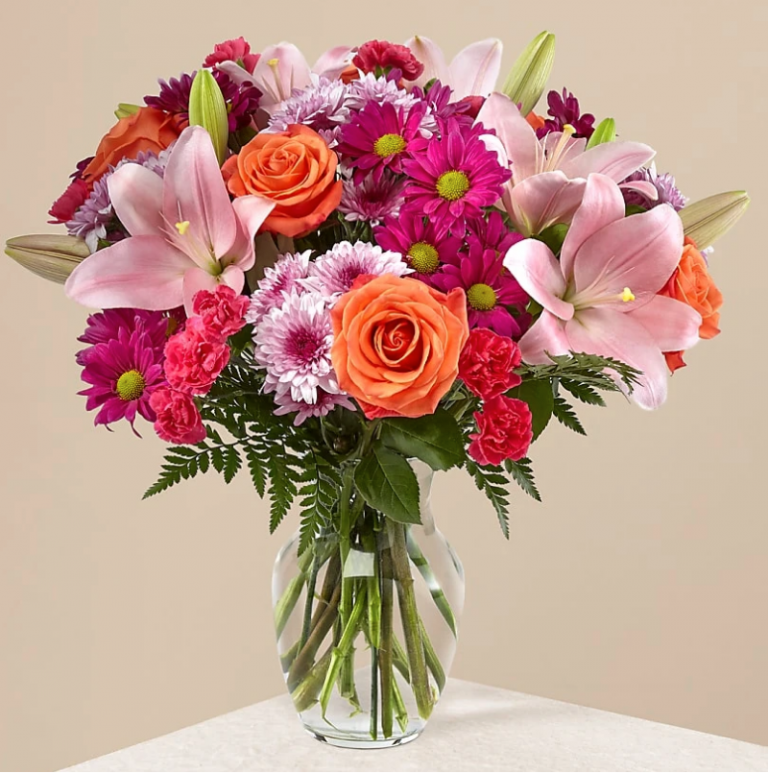 Mix Assortment Of Flowers In A Glass Vase