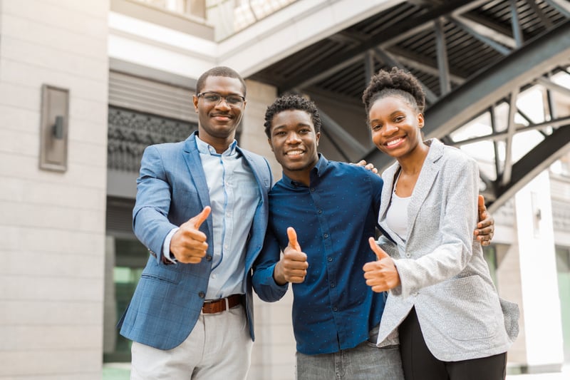 Team of young African people men and women holding a thumbs up